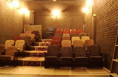 an empty auditorium with rows of chairs and ladders