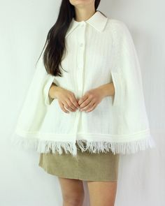 This is such a special piece! This 70s knit poncho cape is so perfect for everyday wear, and can be paired with so many looks and styles. The collar on this piece is lovely, the fringe is fun, and the material (acrylic) is soft and warm. This cape has slits in the front for you to use your arms. This is a button up piece as well, and is in excellent condition for it's age, and for being white! There are no flaws to note. ☼ Brand - Flair Fashions ☼ Material - 100% Acrylic ☼ Color - White ☼ Size - Chic White Cape For Spring, One Size Cream Cape For Fall, One Size Cream Fall Cape, Chic White Winter Cape, Chic White Poncho For Fall, Chic White Fall Poncho, Chic White Cape For Fall, One Size Cream Cape, Oversized White Cape Poncho