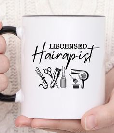 a person holding a coffee mug with the words liscened hair st on it