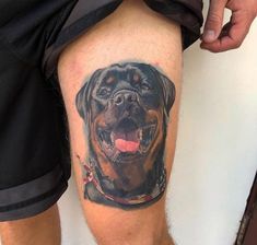 a man's leg with a tattoo of a dog on it and his tongue hanging out