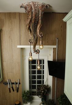 an octopus chandelier hangs from the ceiling