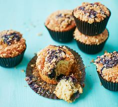 blueberry muffins cut in half and stacked on top of other muffins