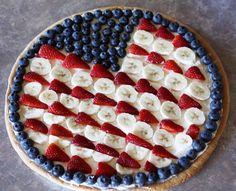 a pie with fruit on it is decorated in the shape of an american flag