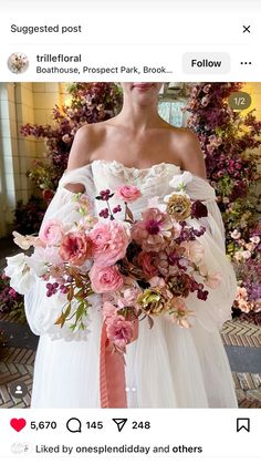 a woman in a white wedding dress holding a pink and green bouquet with flowers on it