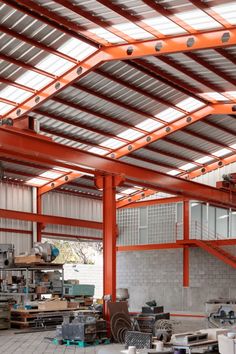 the inside of a large warehouse with lots of items on the floor and in the ceiling