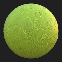 a large green ball with small white flowers on it's surface, against a black background