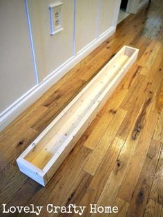 a wooden bench sitting on top of a hard wood floor