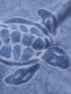 a blue towel with an image of a turtle on it