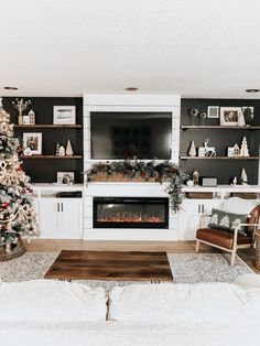 a living room decorated for christmas with white furniture