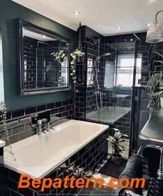 a black and white tiled bathroom with a bathtub, sink, mirror and shower