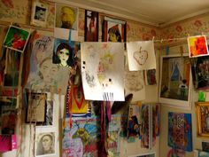 a room filled with lots of art and pictures on the wall