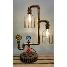 an industrial style steam engine lamp with two lamps on each side and a gauge in the middle