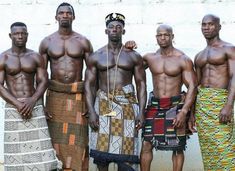 four men standing next to each other in front of a wall with the caption akan of ghana & ivory coast