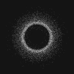 a black and white photo of a circular object with small dots in the center on a dark background