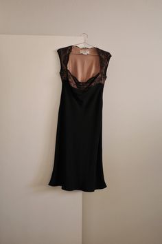 The perfect little black dress for any occasion. By Jones New York Dress in the 90's. This dress has the most stunning cowl lace top, with ribbon detail right underneath the breast to separate the top from the skirt. Bottom of dress has a slight mermaid fit and flare hem. Dress is black and tan. Has a side zipper closure. Labeled a size 10. In excellent condition. Measurements Shoulder - Shoulder: 17.5" Bust: 16" Waist: 13.5" Hips: 21.5" Length: 44.5" Evening Dresses With Lace Top And Fitted Bodice, Formal Lace Dress With Bias Cut, Lace Bias Cut Dress For Night Out, Black Lace Bias Cut Dress, Black Lace Dress With Bias Cut, Formal Black Dress With Lace Top, Black Formal Dress With Lace Top, Fitted Silk Dress With Lace Bodice, Black Lace Top Evening Dress