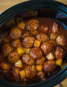 a crock pot filled with meat and potatoes