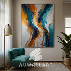 an abstract painting hangs on the wall above a blue chair