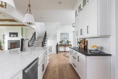 the kitchen is clean and ready for us to use it's white cabinetry