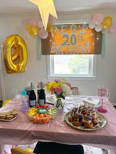 a table topped with lots of food and balloons