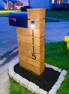 a mailbox sitting in the grass next to a fire hydrant