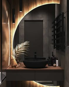 a modern bathroom with wood paneling and black sink in the center is illuminated by lighting