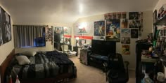 a bedroom with posters on the wall and a bed in it's center area