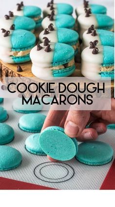 cookies with blue and white frosting are being cut into small pieces to make macarons