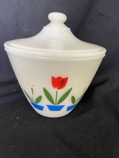 a white bowl with a red flower painted on it