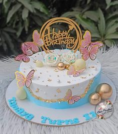 a birthday cake decorated with butterflies and flowers