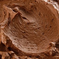 a close up view of chocolate frosting in a bowl