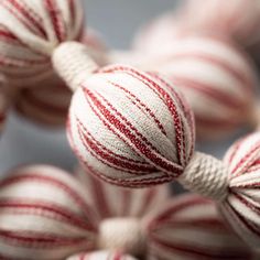 several red and white striped balls hanging from strings