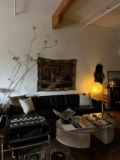 a living room filled with furniture and a painting on the wall