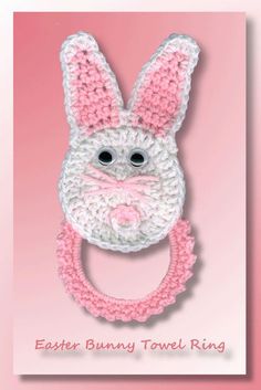 a crocheted bunny towel ring on a pink background