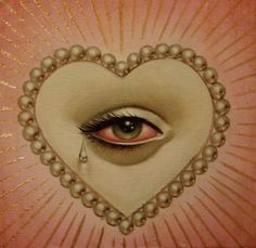 an eye is surrounded by pearls in the shape of a heart