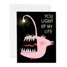 a greeting card with an image of a pink monster that says, you light up my life