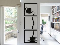 an open door leading to a room with bookshelves and coffee cups on it