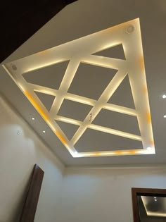 a ceiling with some lights on it and a mirror in the corner next to it