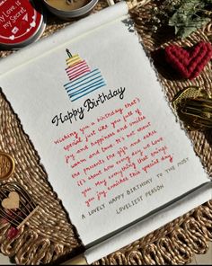 a piece of paper with a birthday message on it sitting next to some other items