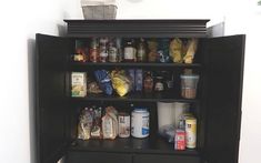 a black cabinet filled with lots of food