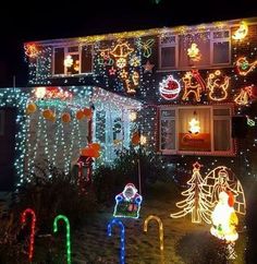 a house covered in christmas lights with decorations on the front and side of the house