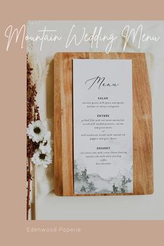 the menu card is on top of a cutting board with flowers in front of it