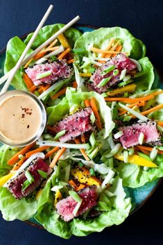 lettuce and carrot salad with dipping sauce on the side, ready to be eaten