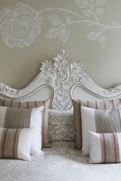 a white headboard with many pillows on it