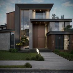 a modern house is shown at night with its lights on and the front door lit up