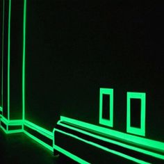 an empty room with neon green lights in it