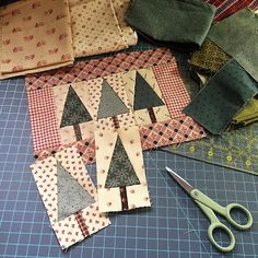 several pieces of fabric laid out on a table with scissors