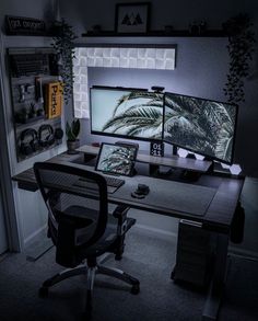 two computer monitors sitting on top of a desk