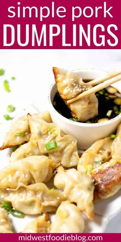 some dumplings are on a plate with chopsticks and sauce in the bowl