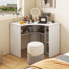 a white desk with a mirror, stool and pictures on the wall in a bedroom