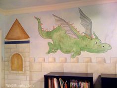 a child's room with a mural of a dragon on the wall and bookshelves